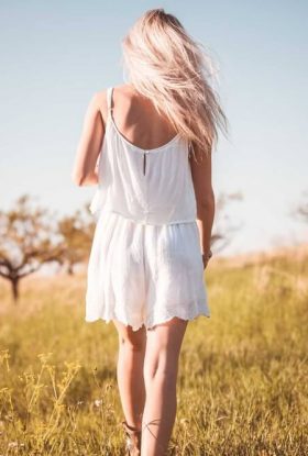 Woman Wearing a White Dress Walking in a Field